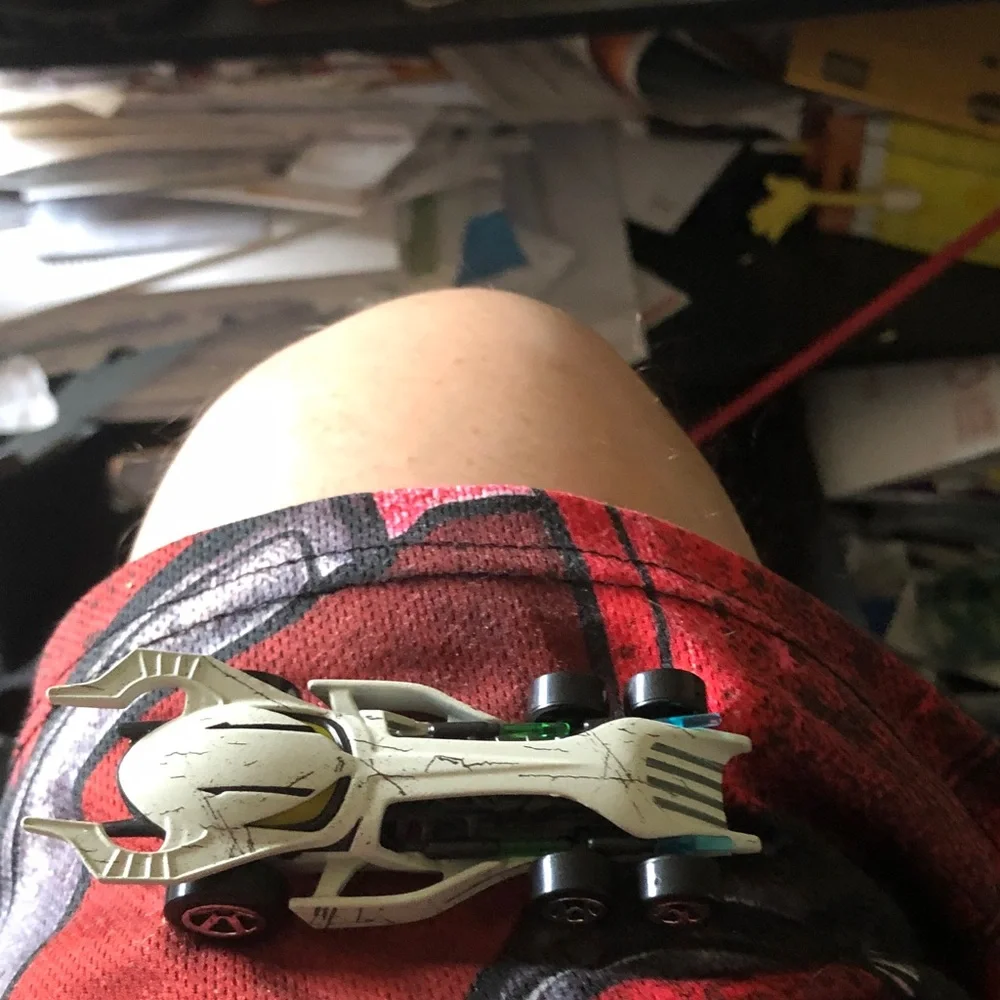 White Skull-Style Toy Race Car with Yellow Accents
